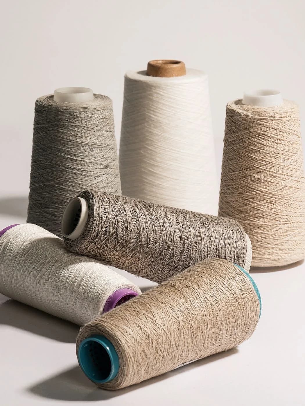Yarn cones in multiple natural tones for material screening